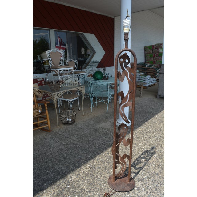 This heavy iron/metal lamp has been gently used. I believe it to be hand crafted, signed, looks like DKR. Footed base. No...