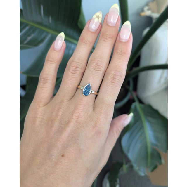 An elegant 2CT blue lab diamond shines with striking brilliance, framed by natural diamond accents for a refined contrast....