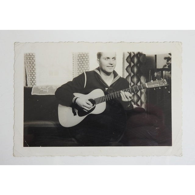 Mid 20th century snapshot photograph of guitar playing sailor. Unframed, corner creases.
