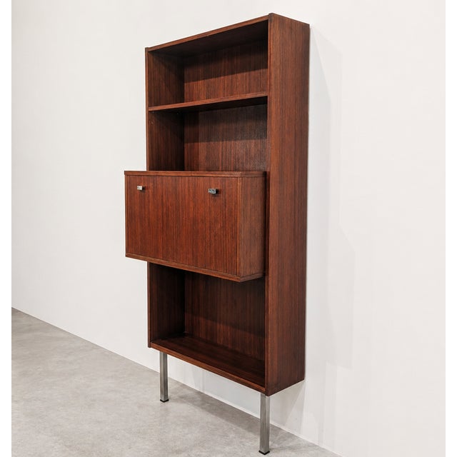 Vintage rosewood wall unit from the 1960s, combining open shelving, a fold-down secretary compartment and a discreet bar...