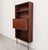 Vintage rosewood wall unit from the 1960s, combining open shelving, a fold-down secretary compartment and a discreet bar...