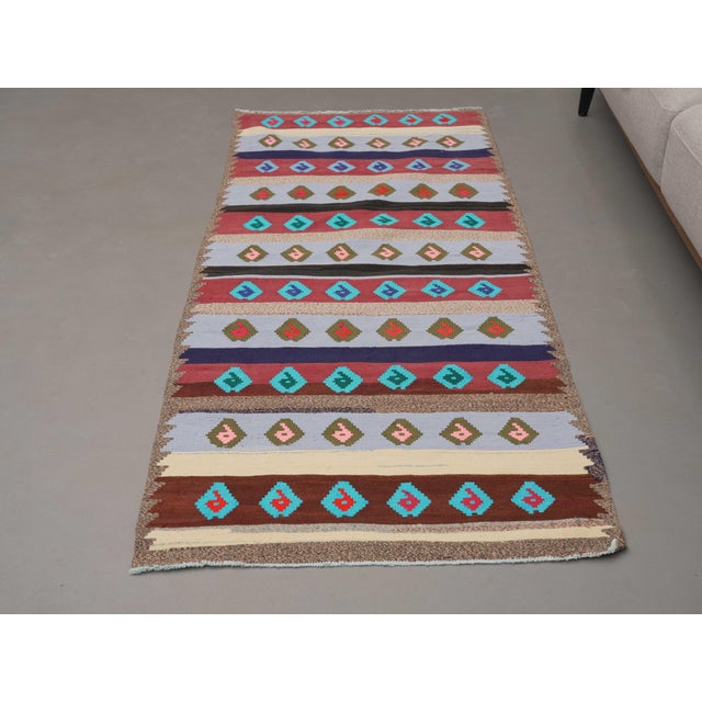 Vintage Hand-Knotted runner rug is a semi-antique vintage area rug. The '70s Eastern region of Anatolia's unique rug is...
