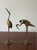 Pair of vintage solid brass crane/heron sculptures, circa 1970s. The set features two complementary poses: one tall...