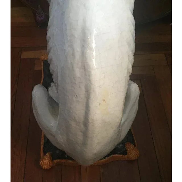 Large life size Italian glazed terra cotta majolica figure of a seated hound dog wearing a studded collar and perched on a...