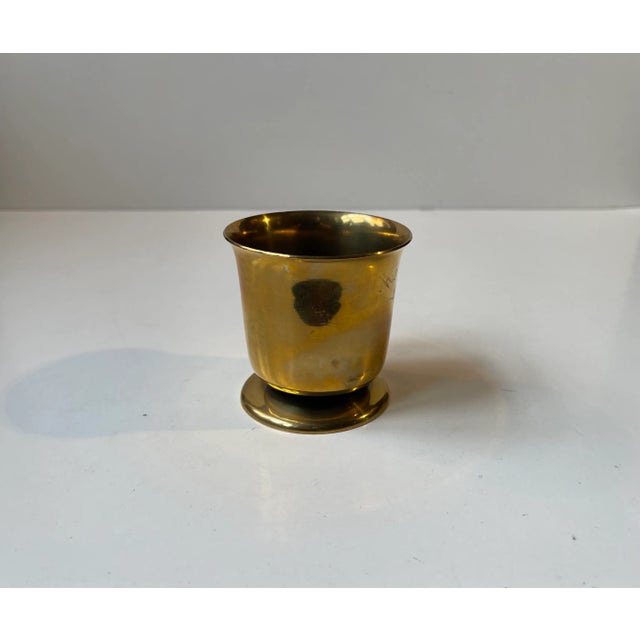 A footed vase or cigarette holder fashioned from solid bronze. Made by Nordisk Malm in Denmark during the 1940s in a style...