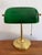 Beautiful brass banker's desk lamp with Emeraldite green glass shade and drawstring pull. A classic and traditional touch....