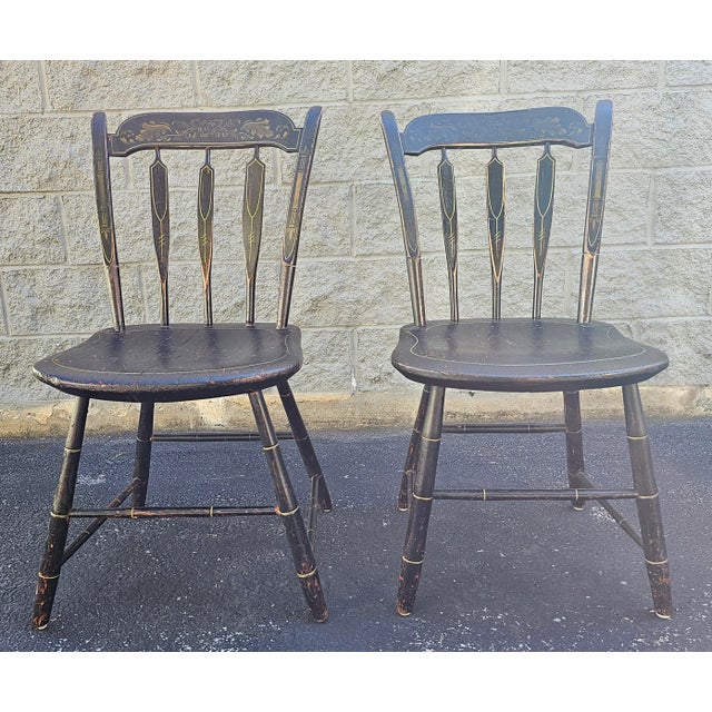 A pair of 19th Century Early American Ebonized and hand painted and decorated side chairs with great patina. Measure 19"...