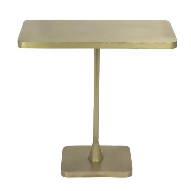 A burnished, richly beautiful antique brass finish elevates the handsome lines of this simple metal side table. Artisan...