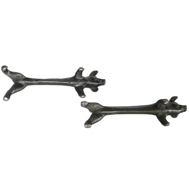 Pair of antique metal knife rests, in the form of elongated pigs. Both are in overall good condition, both show wear to...