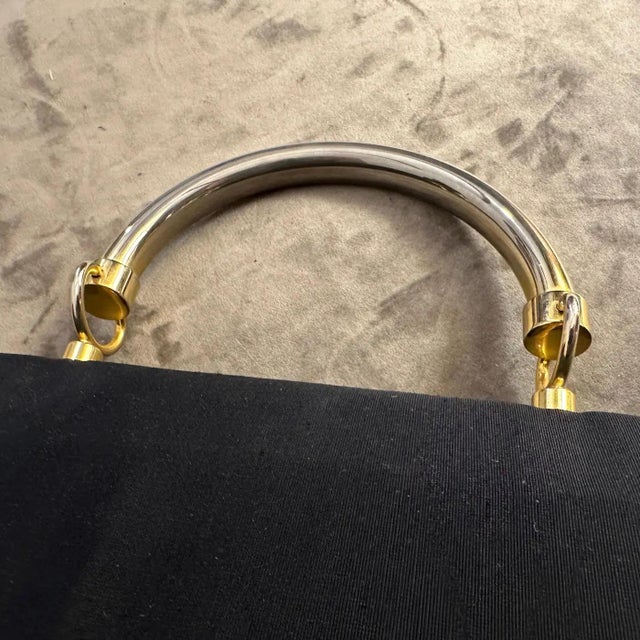 This is a classic example of 1990s minimalist chic. It's a structured handbag with clean lines and a focus on...