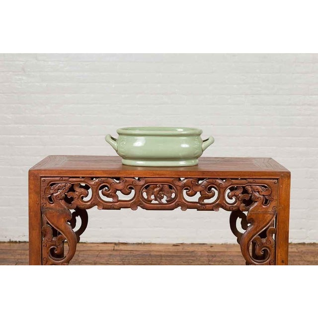 A Chinese vintage celadon foot bath from the mid-20th century, with two handles and foliage motifs. Created in China...