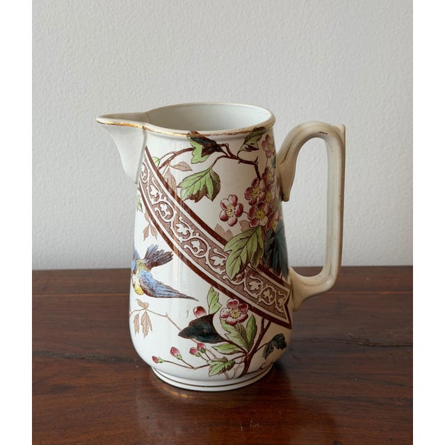 French terre de fer (Ironstone China) jug in the Hanoï pattern, circa 1920s. Decorated with birds and flowering branches...