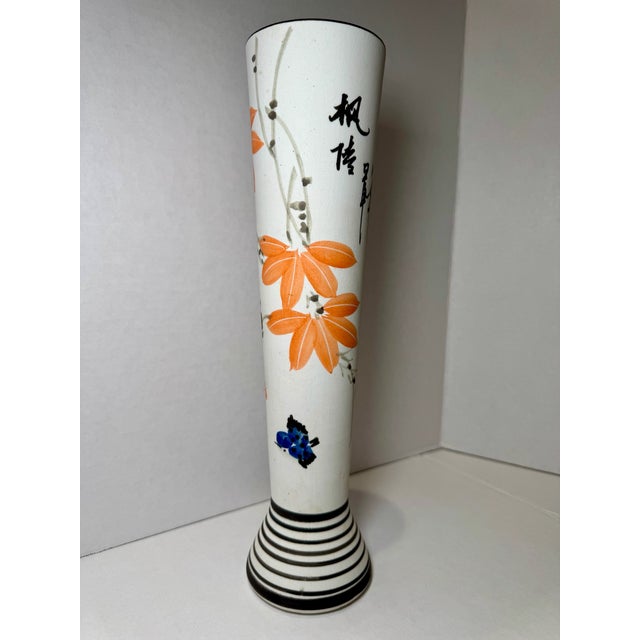 Hand-painted porcelain trumpet-form vase featuring orange floral decoration, calligraphic inscription, and red seal mark....