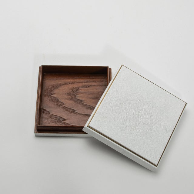 This set of three square boxes by R&Y Augousti is a masterclass in luxury craftsmanship, merging sleek design with...