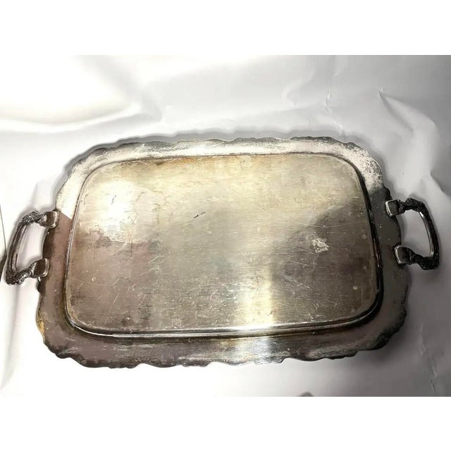 A handsome vintage silverplate butler's tray by Oneida, featuring a generously proportioned rectangular surface,...