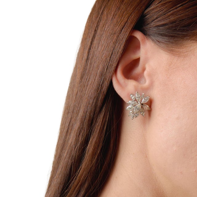 These striking Mid Century cluster earrings showcase an impressive arrangement of 24 marquise cut diamonds totaling...