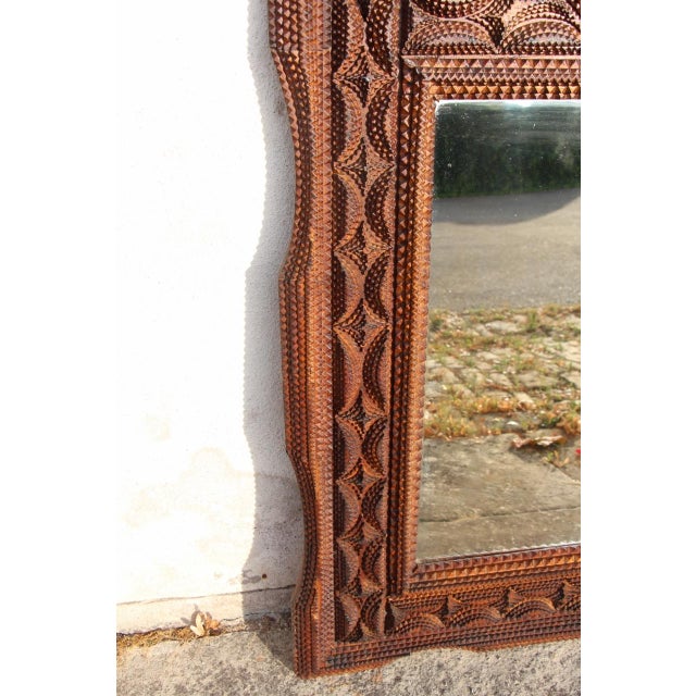 Tramp Art style mirror, typical of 19th-century folk art, probably of French origin. The frame is meticulously hand-carved...