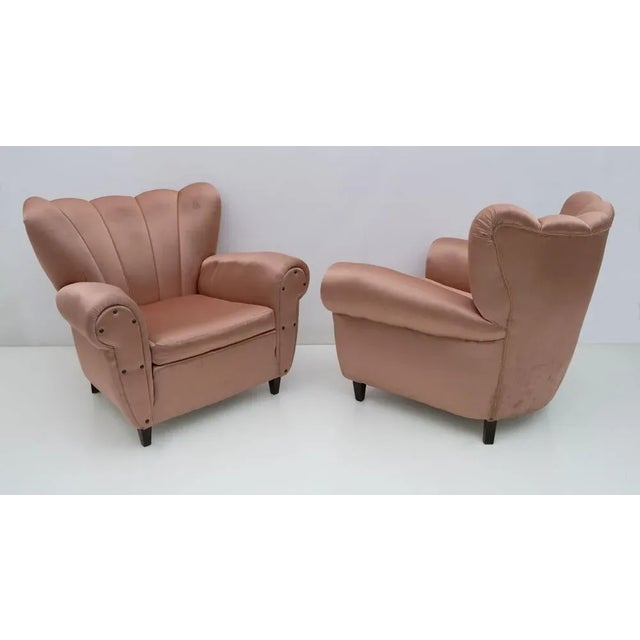 Pair of armchairs in the Ulrich style, structure and legs in solid wood, covering in satin, made in the 1950s Conditions...