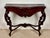 Elegant 20th century console table crafted in richly carved wood with a beautifully shaped silhouette. The piece features...