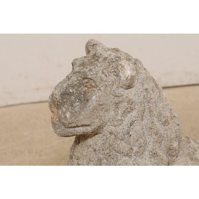 A European carved stone lion garden statue from the 18th century. This antique sculpture from Europe has been hand-carved...
