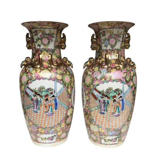 A pair of large china vases, 20th century. Detailed with matching garden scenes and floral decorations. Offered in...