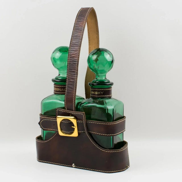 Stunning Mid-Century-Modern 1960s barware accessory, tantalus, or cave a liqueur. The hand-stitched brown leather case is...