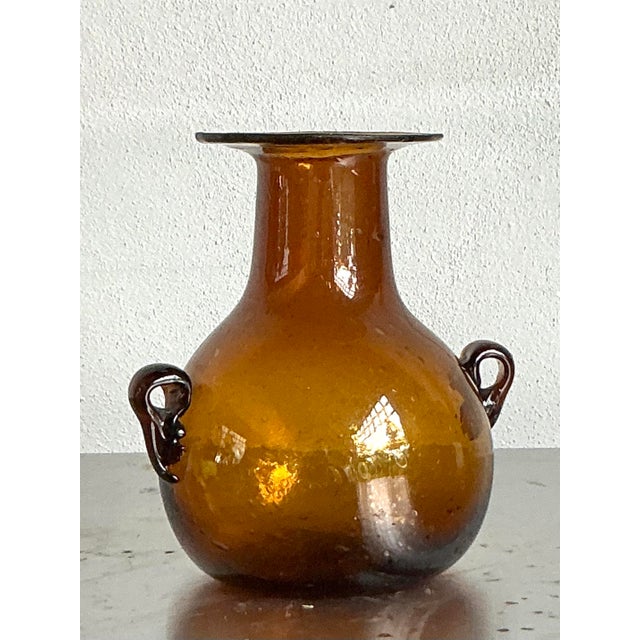 Elevate your space with this charming vintage blown glass vase, a testament to artisanal craftsmanship from the mid-20th...