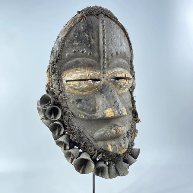 A beautiful, large mask with the famous protruding lips of the Dan carver. The trader indicated that this mask, with bells...