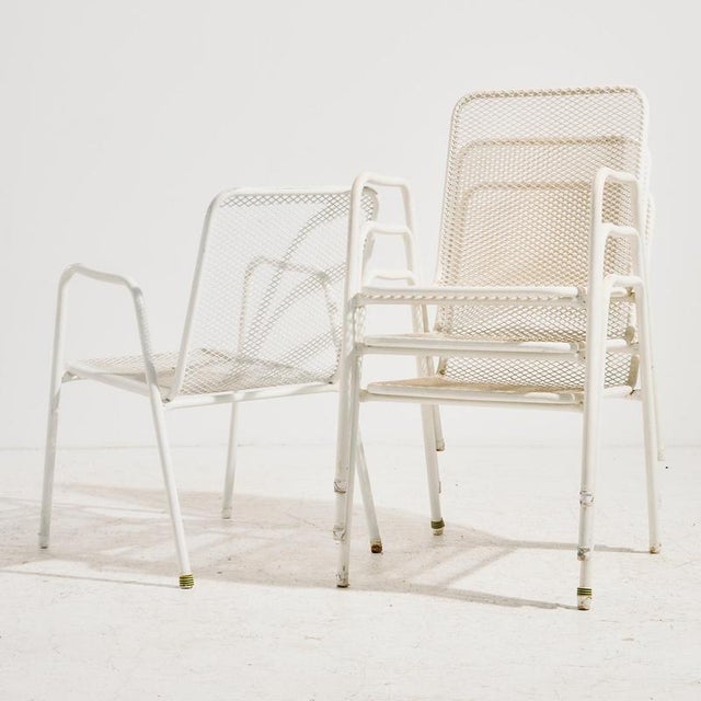 Stackable garden armchair on tubular metal frame from the 1980s. with some surface scratches, rust and wear on the metal...