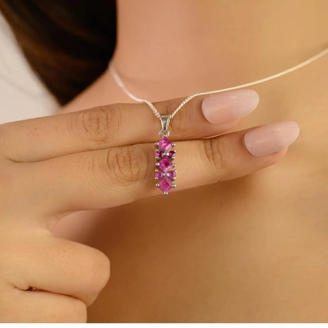 This stunning pendant is crafted in 925 sterling silver and features vibrant rubies in an elegant prong-set design. The...