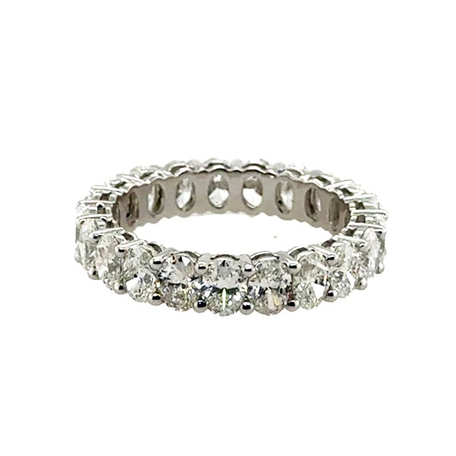 18k White gold eternity band with 21 colorless natural oval brilliant diamonds weighing 4.07 carats. 3.70g