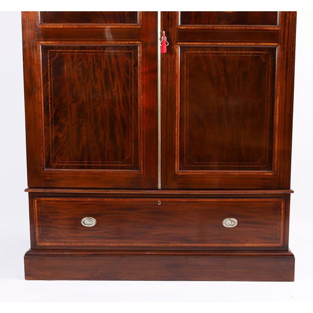 This is a lovely antique high quality english george iii revival flame mahogany and satin wood banded two door wardrobe,...