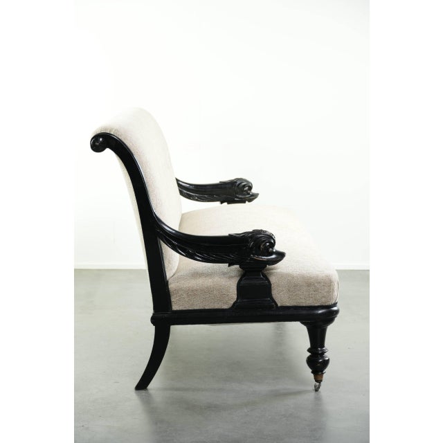 This luxurious French Empire-style sofa has been reupholstered in a soft cream-colored fabric and features unique dragon-...
