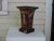 Pair of tole peinte beaker form jardinieres with pastoral figures and scenery on all four sides. Claw feet support each...