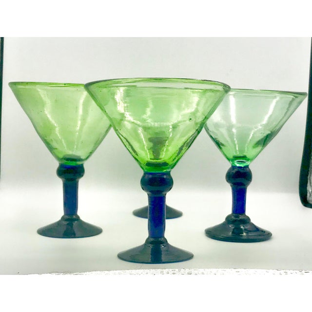 Lovely artisanal rustic yet modern hand blown martini or margarita glasses. The bowl is green glass with a subtle bubble...