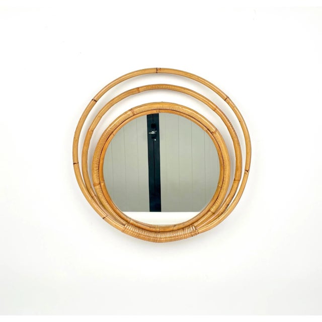 Round wall mirror framed by three-leveled bamboo and rattan circles made in Italy in the 1960s.