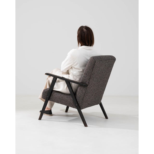 This 1960s Czech Upholstered Armchair encapsulates the essence of vintage appeal with its textured upholstery in muted...