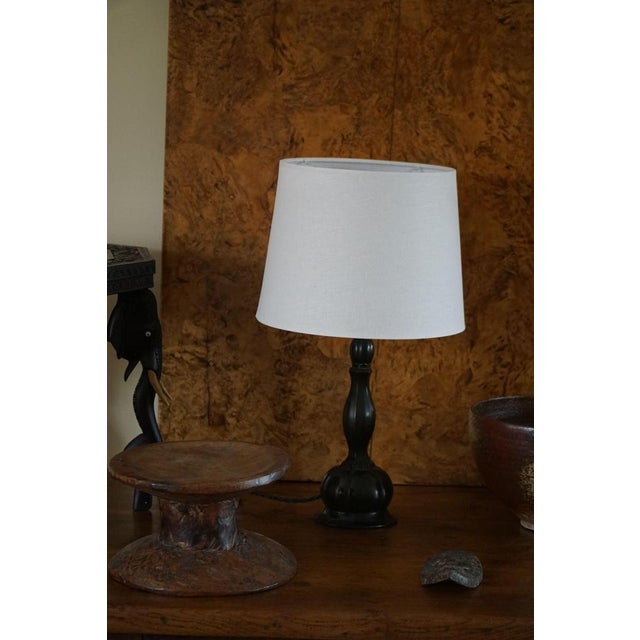 A classic table lamp in patinated disko metal. Made by danish designer just andersen in the 1920s. Model d80, signed...