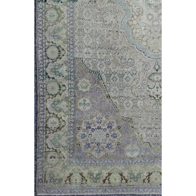 This beautiful rug from mid-20th century Turkey features a traditionally European design. The faint cream ground is home...