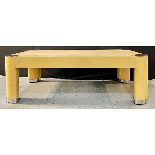 Ron Seff oval leg cocktail table ca. 1985, in lacquered parchment framing a shagreen top with oval polished steel discs at...