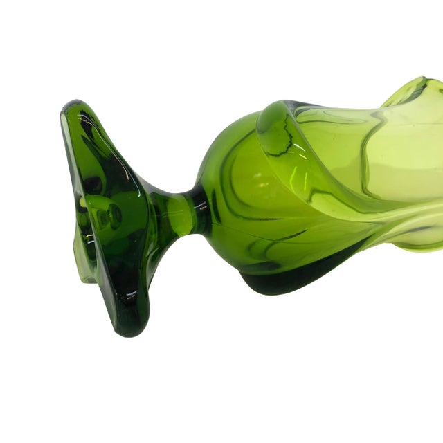 Beautiful footed green vase made in the mid century. Excellent condition. Measurements: 5"W (Base) x 6"D (Top) x 13"H