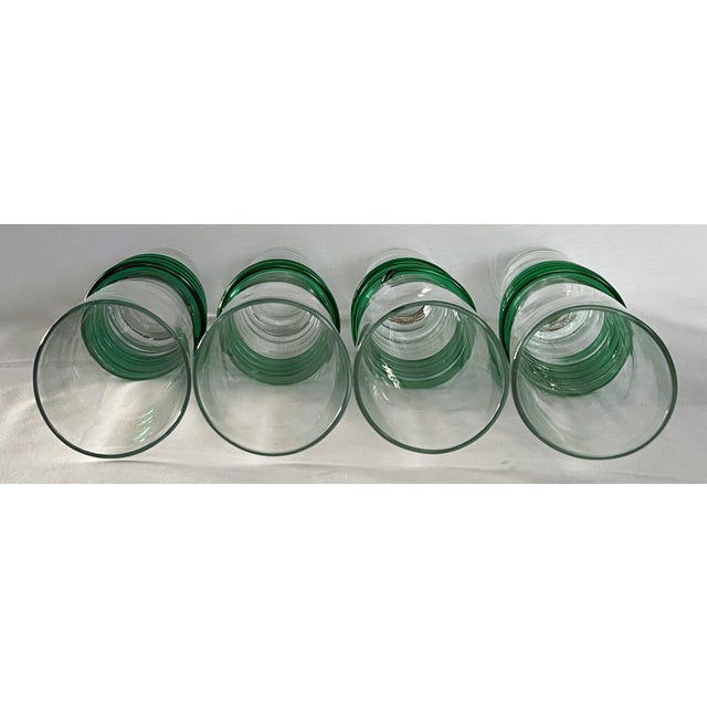 Bring a vibrant touch of contemporary artisan craftsmanship to your table with this striking set of four hand-blown extra-...