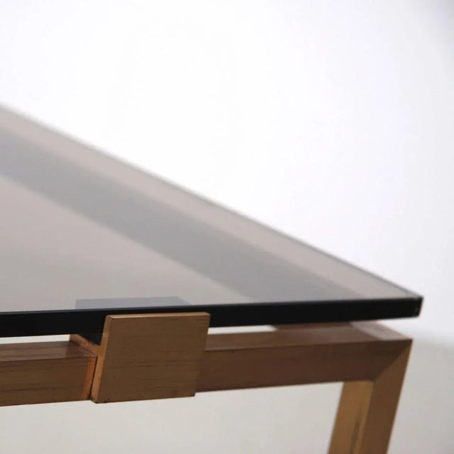 Solid brass base and smoked glass top. Very architectural piece with elegant proportions. High quality.