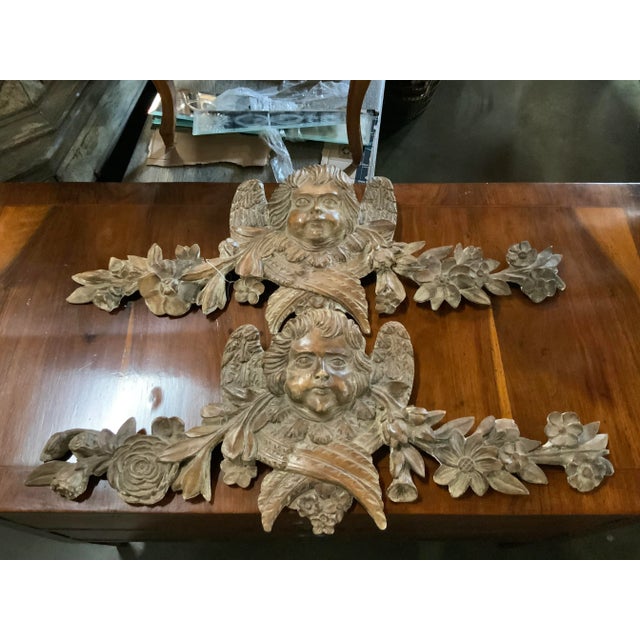 This is a "near" pair of Italian hand-carved Putti wall plaques. This near pair of decorative plaques have a beautiful...