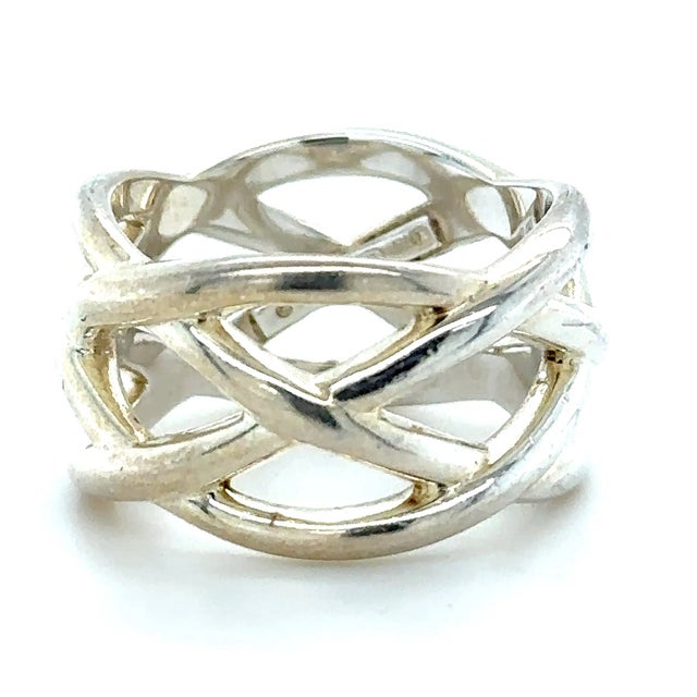 A rare Tiffany & Co. braided knot ring crafted in sterling silver, featuring an intricate woven design with a bold wide...