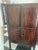 A striking antique Chinese wedding cabinet (婚柜), hand-painted in cinnabar red lacquer with intricate gilt decoration...