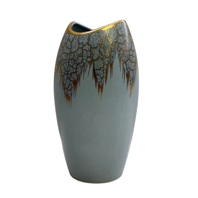 A striking vintage German ceramic vase featuring a tall, gently tapered form with an asymmetric sculptural opening. The...