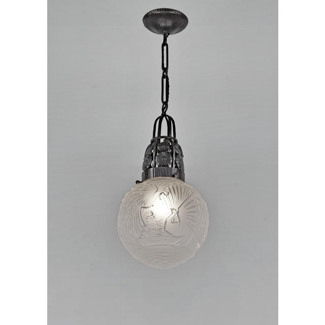 Marcel Vasseur & Muller frères A wonderful French art deco pendant in wrought iron. The richly worked fixture holds a ball...