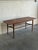 This rectangular teak coffee table combines a long narrow top with a full-length slatted lower shelf. Rounded corners and...