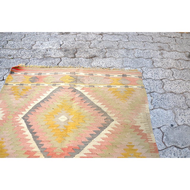This is a vintage Turkish Anatolian kilim rug from the 1960s. The piece was hand-woven.